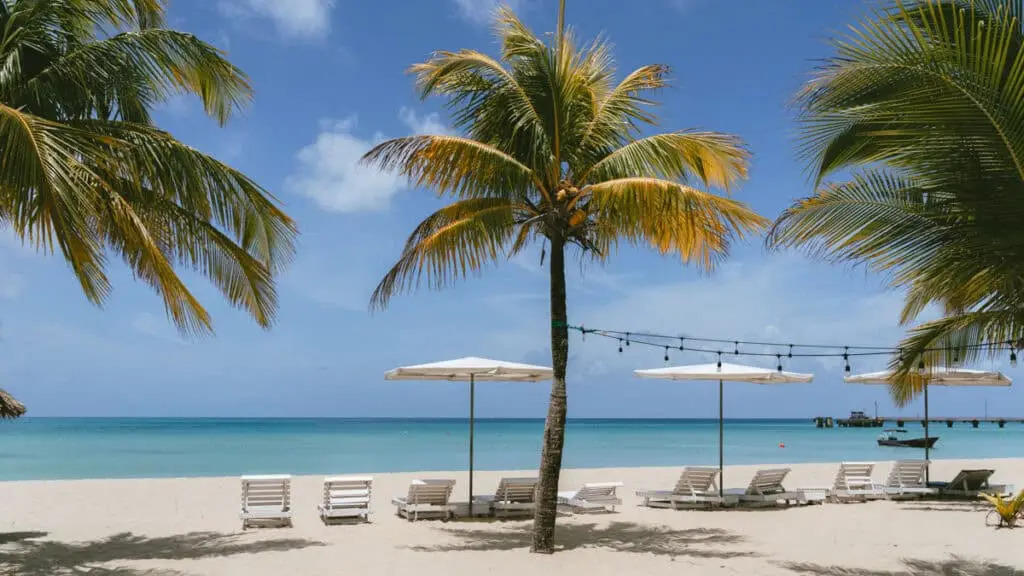 Big Corn vs. Little Corn palm-lined beach with lounge chairs and turquoise water