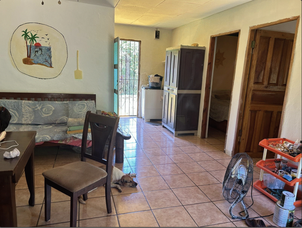 Fully furnished living space inside Little Corn Island House for rent with custom couch and tiled floors