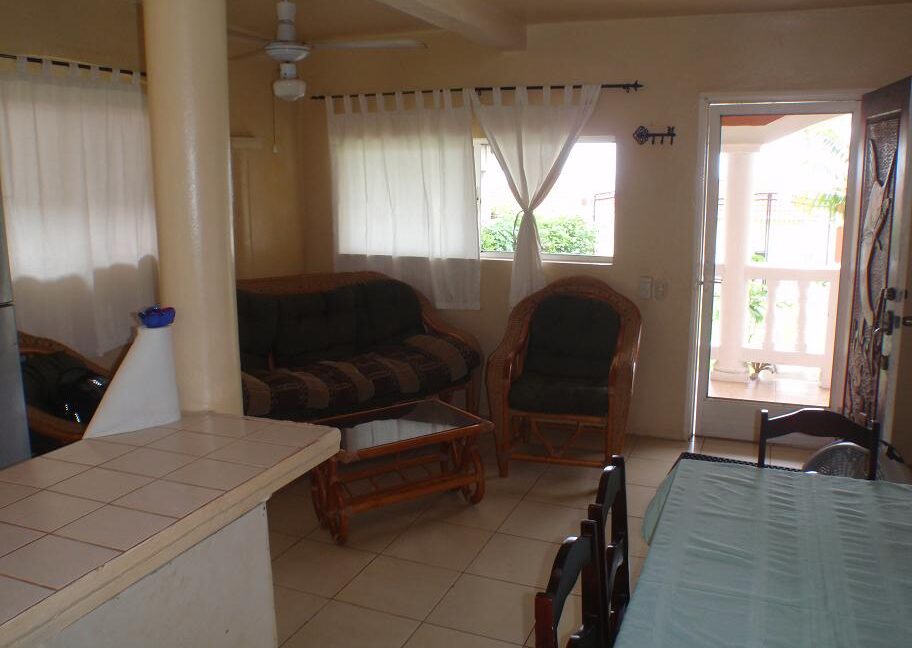 Spacious living room inside Big Corn Villa for Sale overlooking turquoise water