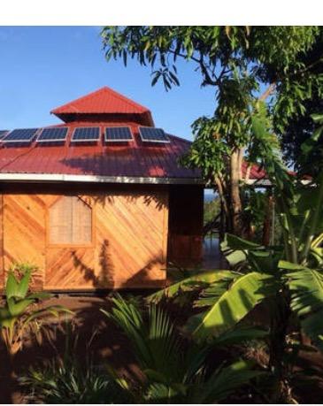 Sunny hillside exterior of House for Sale Little Corn Island with Caribbean Sea views