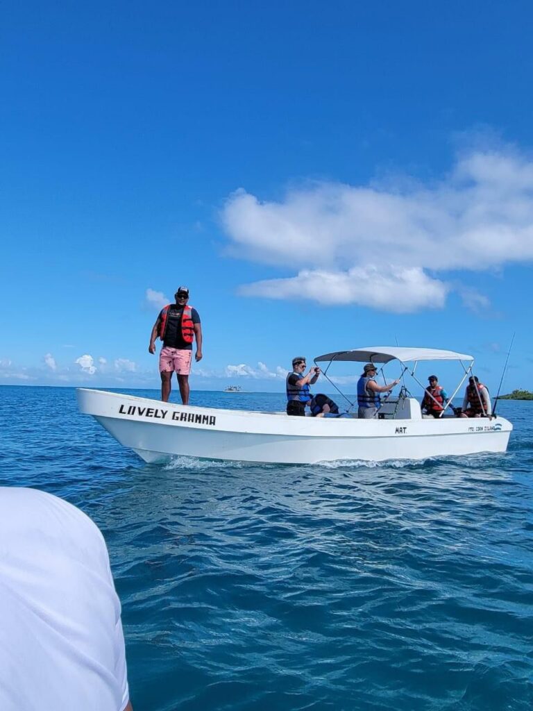 Corn Island Tours boat heading out on calm Caribbean waters