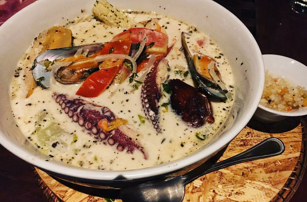 Hearty bowl of Rondon Corn Islands showcasing seafood and coconut broth