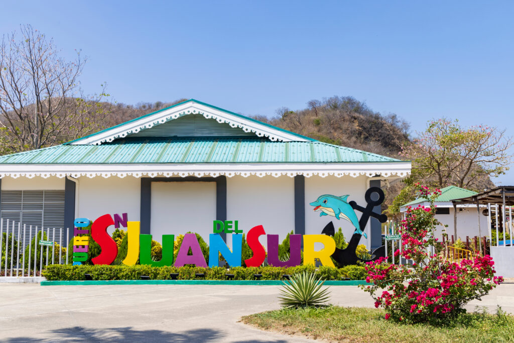 San Juan del Sur, Nicaragua - Colorful touristic placename sign with dolphin and anchor in center of San Juan del Sur in Nicaragua