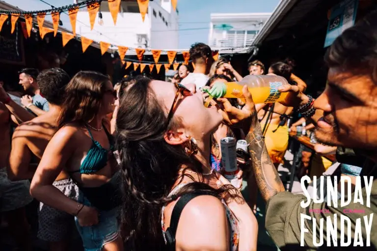 Pachamama Hostel Nicaragua Sunday Funday girl taking a shot in a crowd of travelers dancing to music