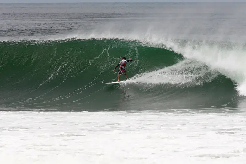 Tola, Rivas man on surfboard surfing the waves.